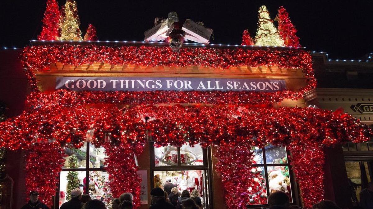A holiday store is lit with red and white lights during the Carol of Lights holiday event in Grapevine.