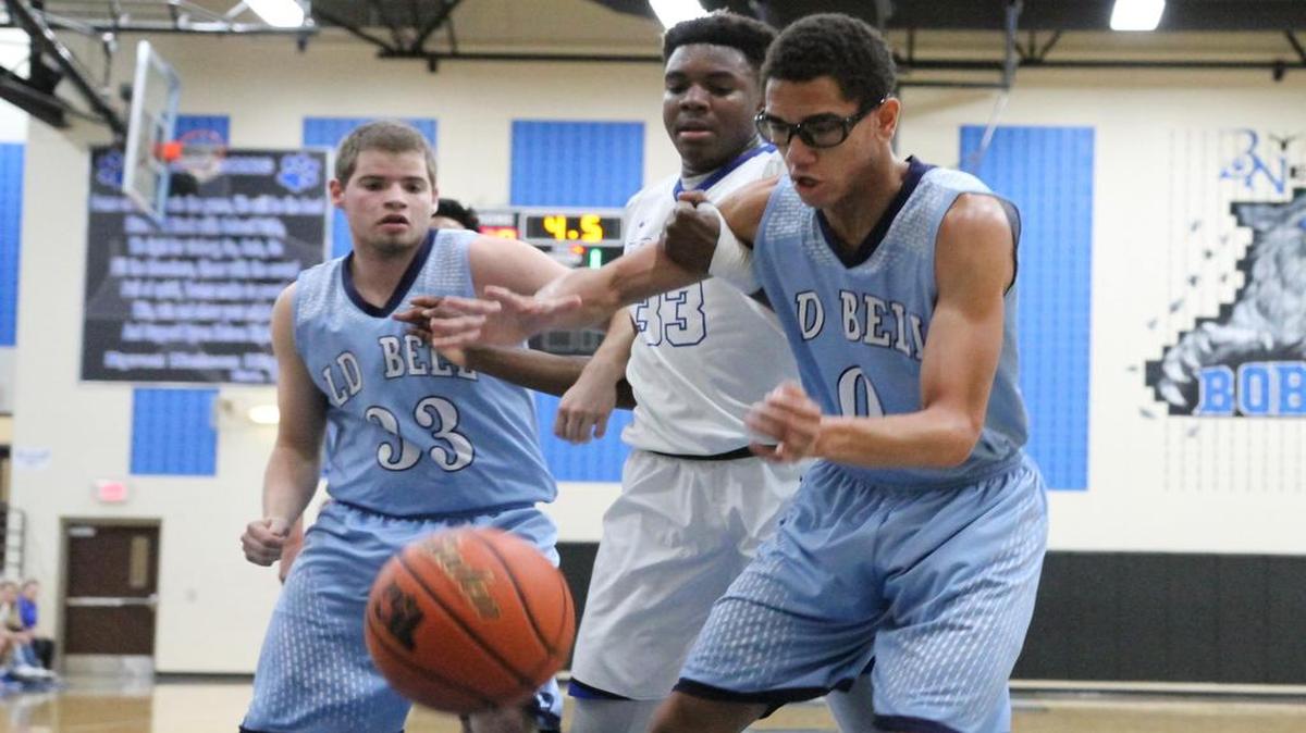 Boston Billings (33) and teammate Oland Carter (0) contend with Byron Nelson’s David Nzekwesi for a loose ball in district play earlier this season.
