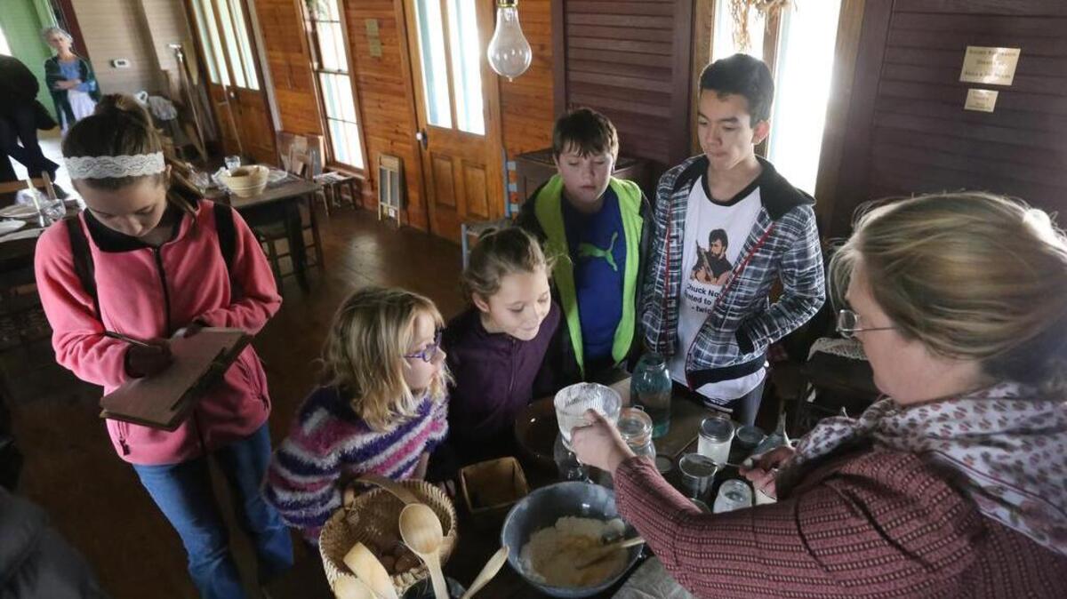 Sharon Heard-Cross, interpretive host at Nash Farm in Grapevine, shows a cooking technique to, pictured from left, Emily Ryter,14, Sami Smith,9, Rachel Ryter, 9, Trey Gower, 11, and Cody Richardson, 15, during a session called the Frugal Farm Wife. During the session, various types of domestic duties typical in a 19th century home were demonstrated.