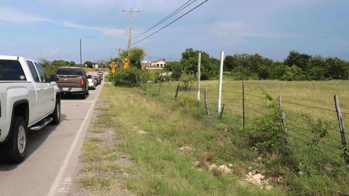 Northwest trustees recently approved the purchase of 140 acres bordered by Avondale Haslet Road, at far left, to the north and railroad tracks on the east for a future high school and middle school. Here, traffic backs up in late afternoon on July 7 while train cars are moved from a nearby BNSF facility.