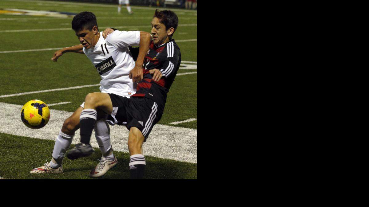 
Carroll No. 11 Ricardo Becerra battles a South Grand Prairie opponent for the ball in Thursday’s game, in which Becerra kicked the goal that made the difference.
