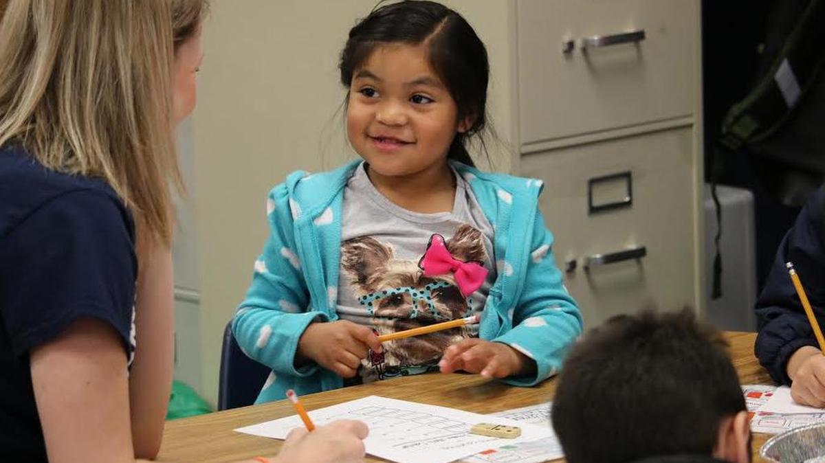 A teacher works with a pre-kindergarten student at Silver Lake Elementary School.