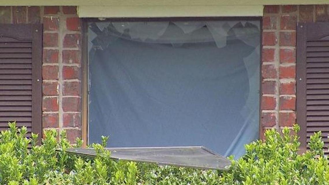 
Windows were smashed during a raid Tuesday by federal agents and police at this home in Trophy Club. One man was arrested, accused of transporting and possession of child porn, federal officials said.
