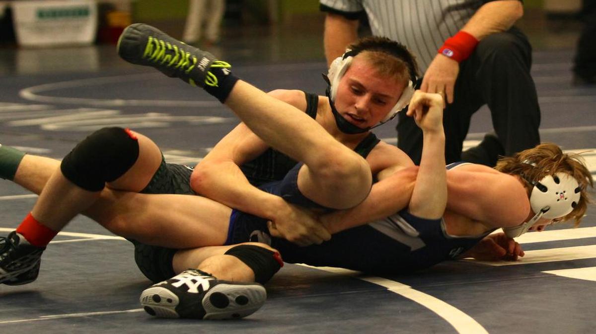 Cameron Haddock, top, has his sights set on a state wrestling championship next year for Carroll.