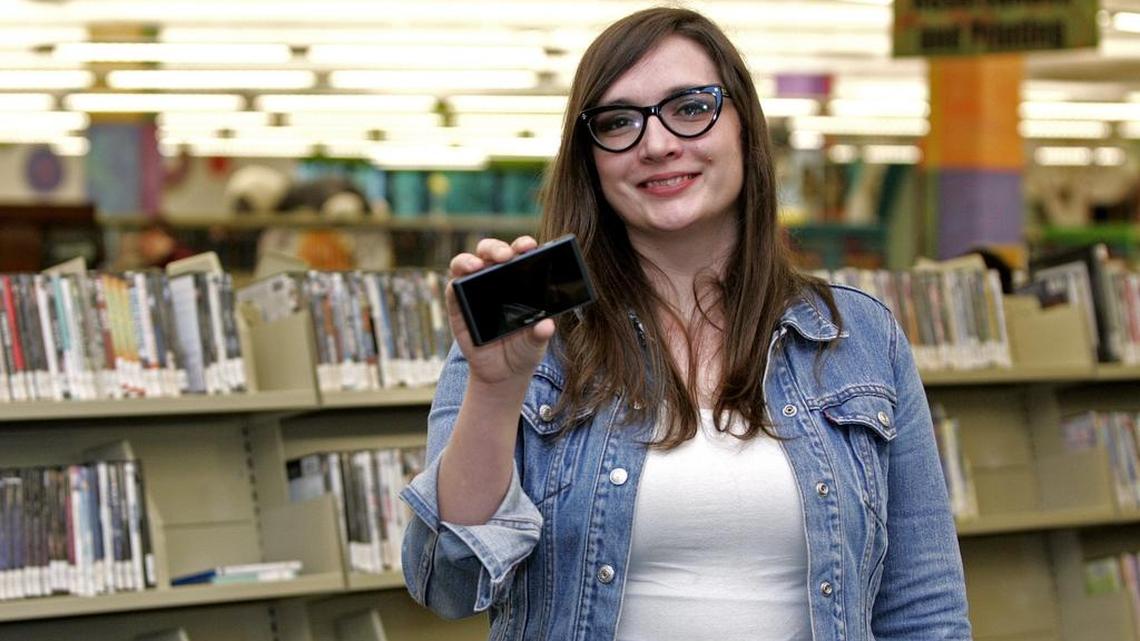 Keller Library Services Manager Rae Cheney shows off one of the library’s new hotspot devices.