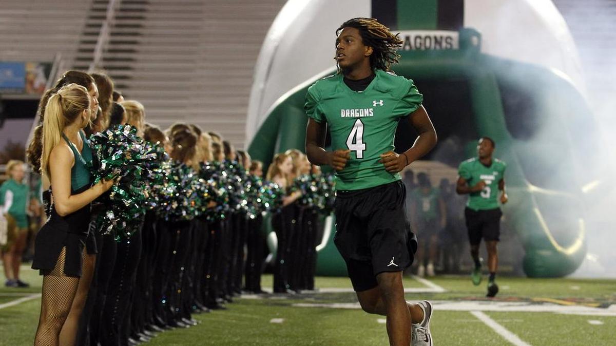 
Carroll running back Lil' Jordan Humphrey runs onto the field at a pep rally at Dragon Stadium. He and other top players sat out the Duncanville scrimmage.
