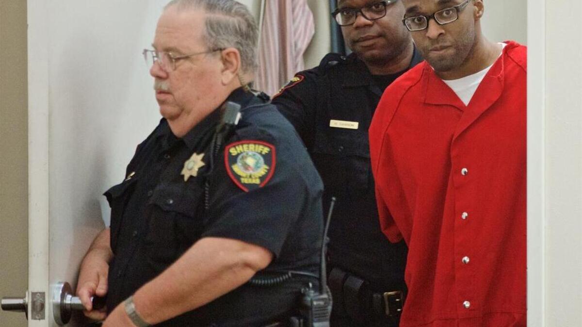 Paul Storey, right, is led into state District Judge Robb Catalano’s court for a recent hearing in Fort Worth. Storey was convicted of capital murder in 2008 for the shooting death of Jonas Cherry.