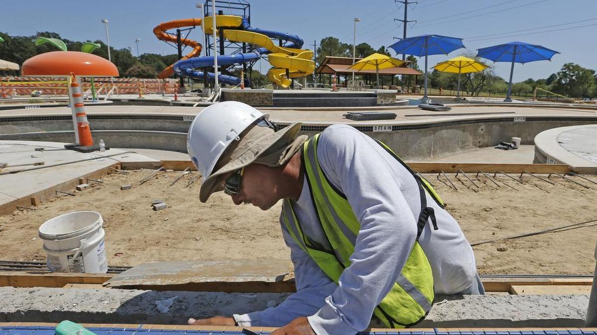 
Roberto Tobias installs tile on one of the pools at the Chisholm Aquatics Center in Hurst.
