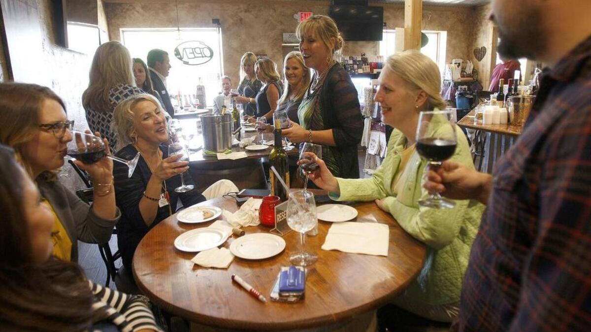 A group of professionals meet at Silver Dollar Winery in Bedford on a recent weekday.