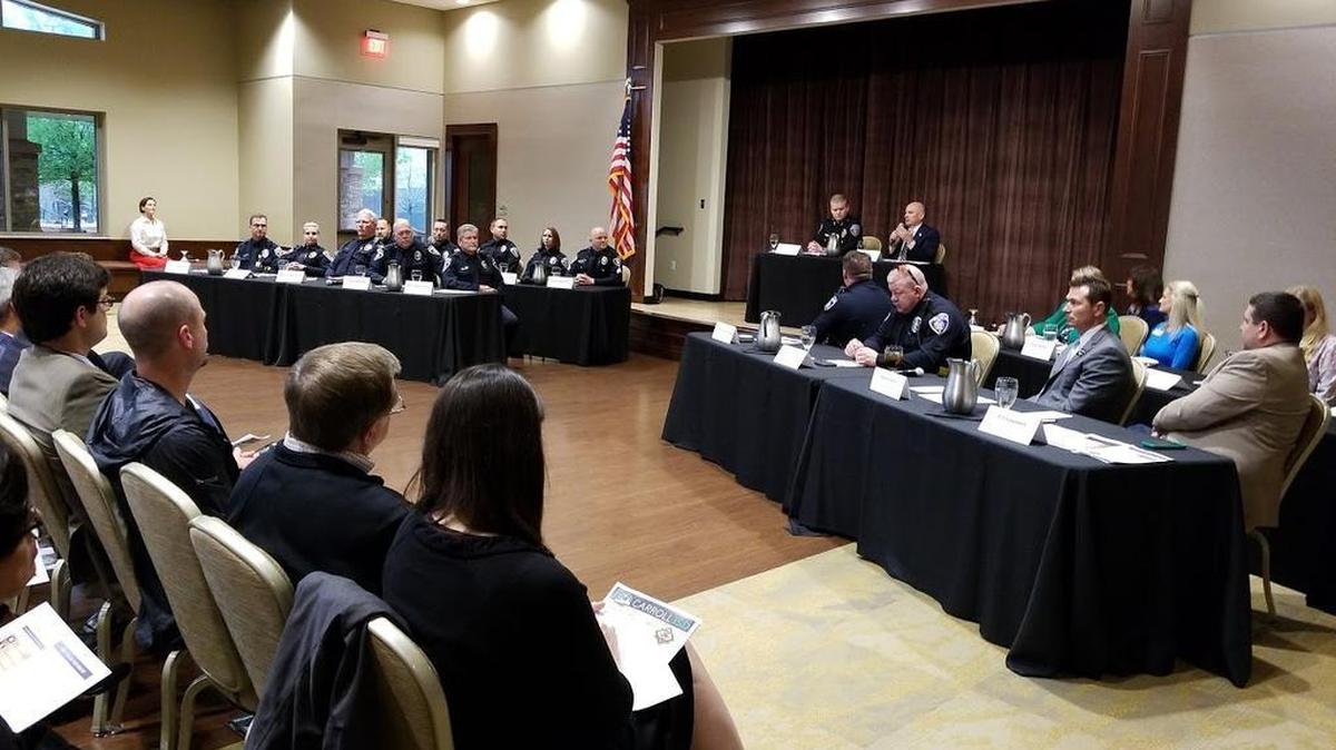 Police Chief James Brandon and Superintendent David Faltys, both onstage, talk about safety in the Carroll school district during a public meeting Wednesday at The Marq. About 100 resident attended.