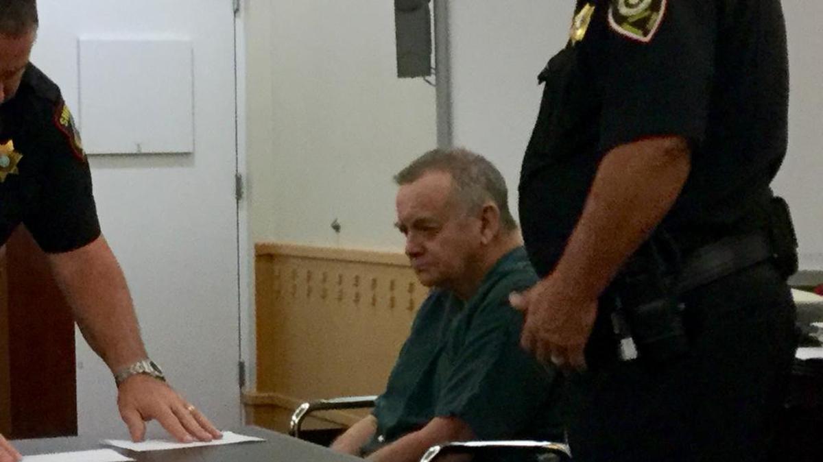 
Harold “Mickey” Moore waits to be fingerprinted after being sentenced to 18 years in prison for his 8th DWI conviction.
