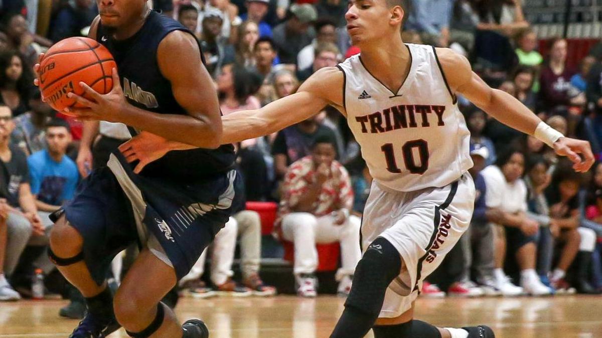 Trinity guard Jhivvan Jackson (10) guards a Richland player last season. Jackson had 31 points in the Trojans’ season opener.