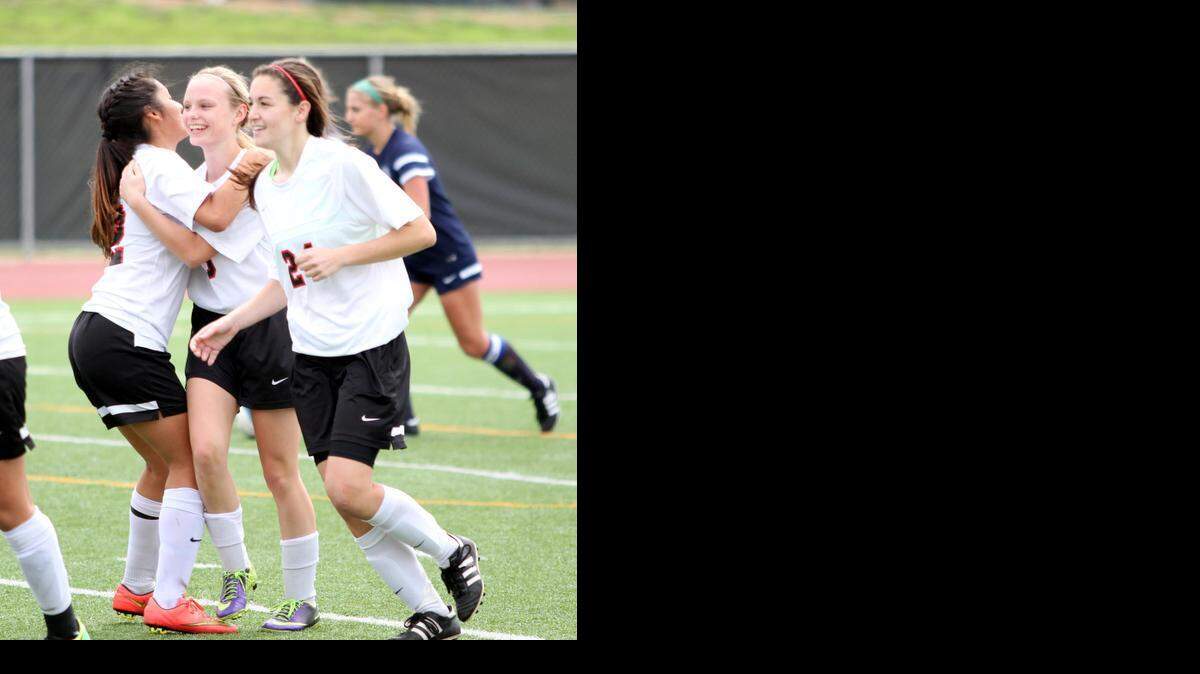 
Kaycee West, center, is congratulated by teammates after kicking the go-ahead goal against L.D. Bell last Saturday.
