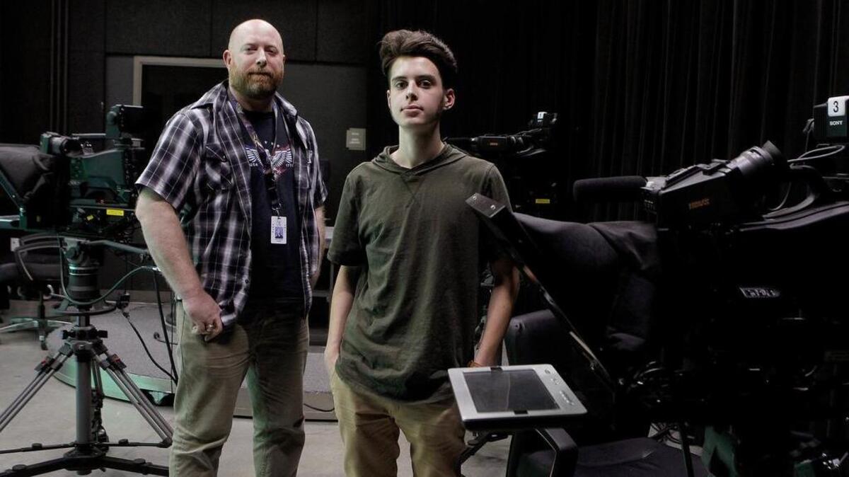 Student Dylan Banfield and his film teacher Lance Moran are photographed at Buinger Career & Technical Education Academy in Bedford on April 6.