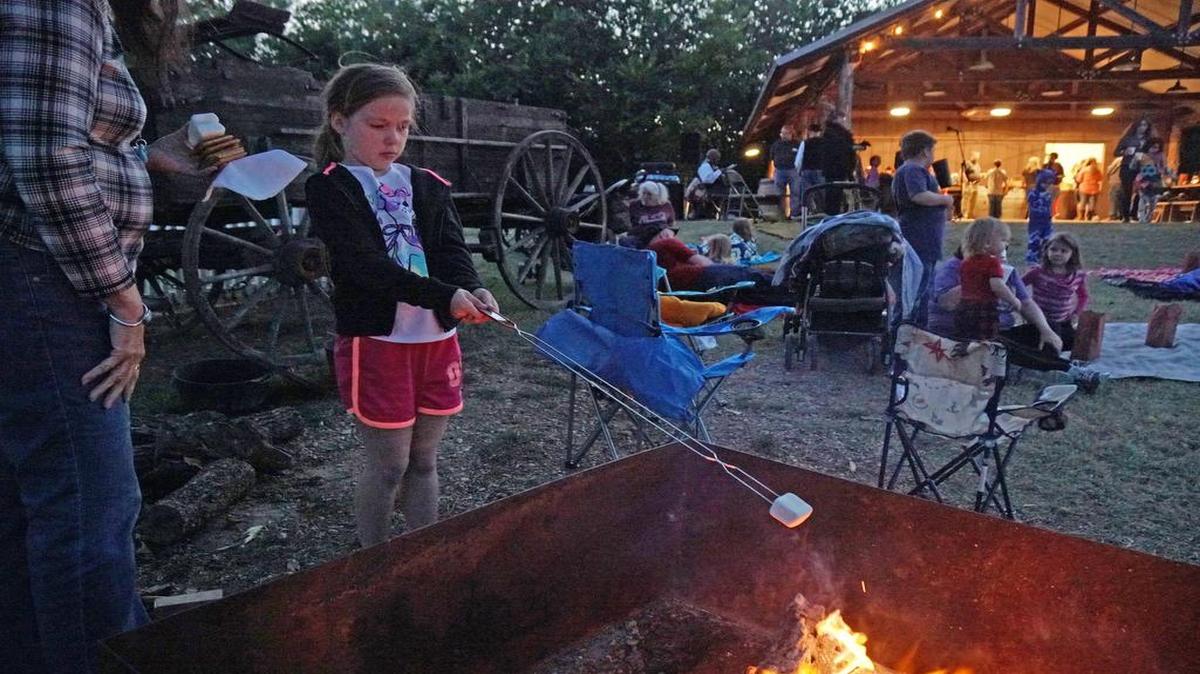 Addison Villarreal, 7, roasts marshmallows Saturday at Grapevine’s Nash Farm. Scary stories were told by Tarrant Area Guild of Storytellers.