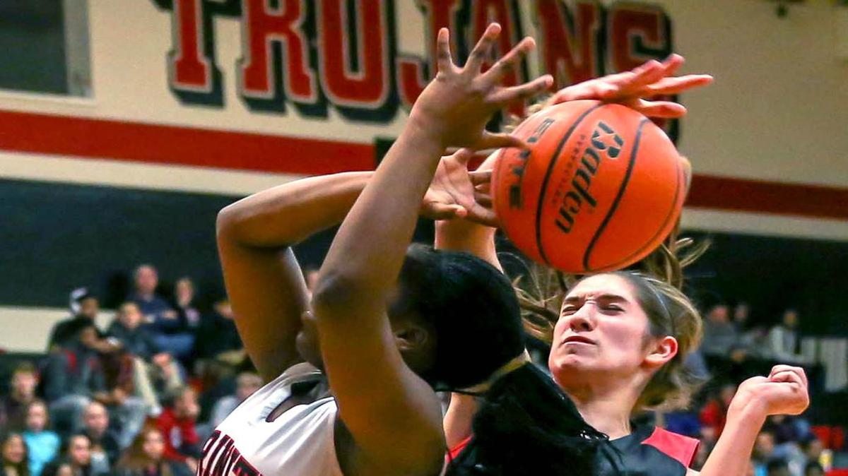 Despite being a defense-first player, Colleyville Heritage guard Caitlyn Foster (right) led her team in scoring in their second game against Grapevine.
