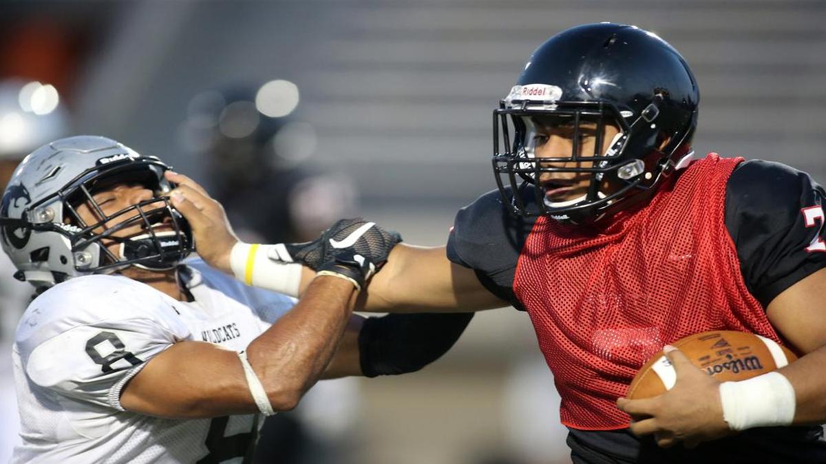 Trinity quarterback Malini Maile, right, is the starter after spending two seasons as the backup.