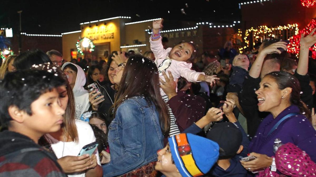 Isabella Guerra, 3, is held up by her father as artificial snow begins to fall during the lighting of Grapevine’s Christmas Tree on Main Street. The evening festivities included a choir, an orchestra, fireworks and the tree lighting.