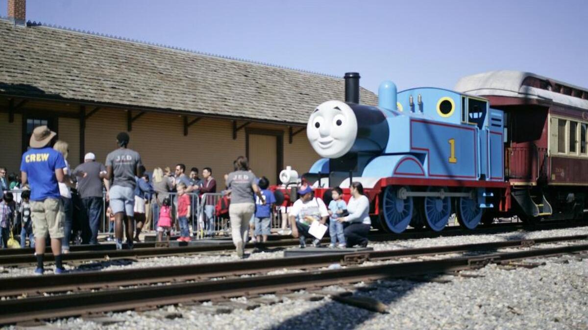 During about a 15-minute, layover people line up to have a photo taken with Thomas during a Day out with Thomas at the Grapevine depot.