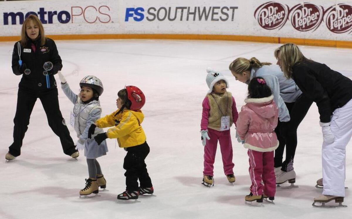 Young skaters chase bubbles during an ice skating lesson at the Dr Pepper StarCenter in Euless.