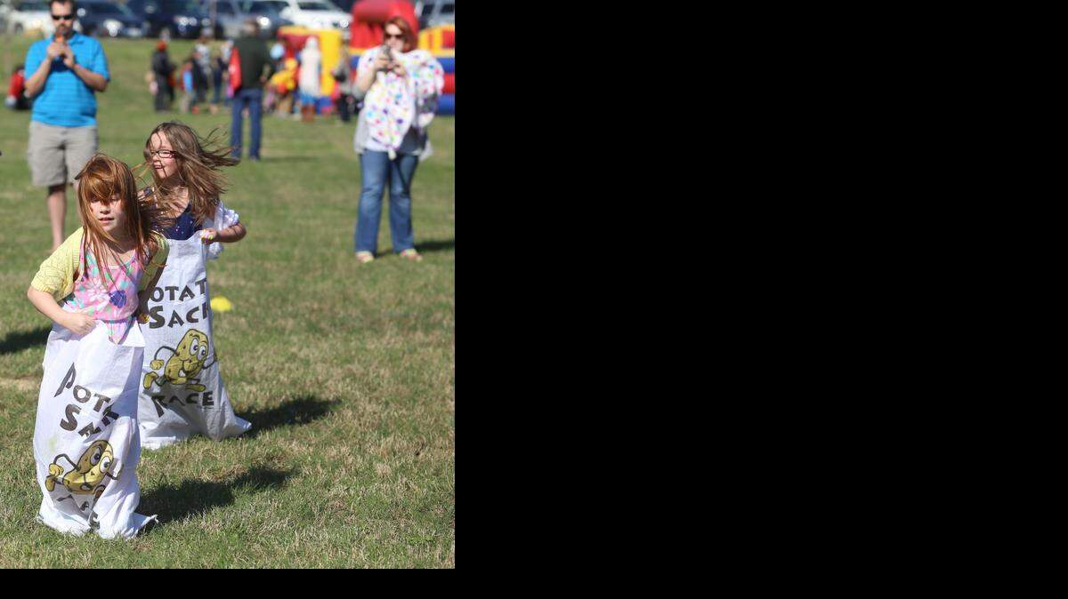 
Chloe Arnold, 7, front, and Jacey Goodell, 7, participate in a sack race at the event. 
