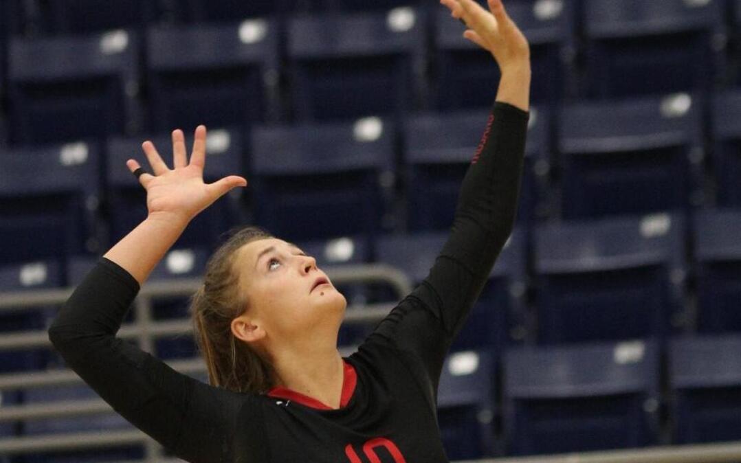 Elli Merchant serves for the Trinity volleyball team.