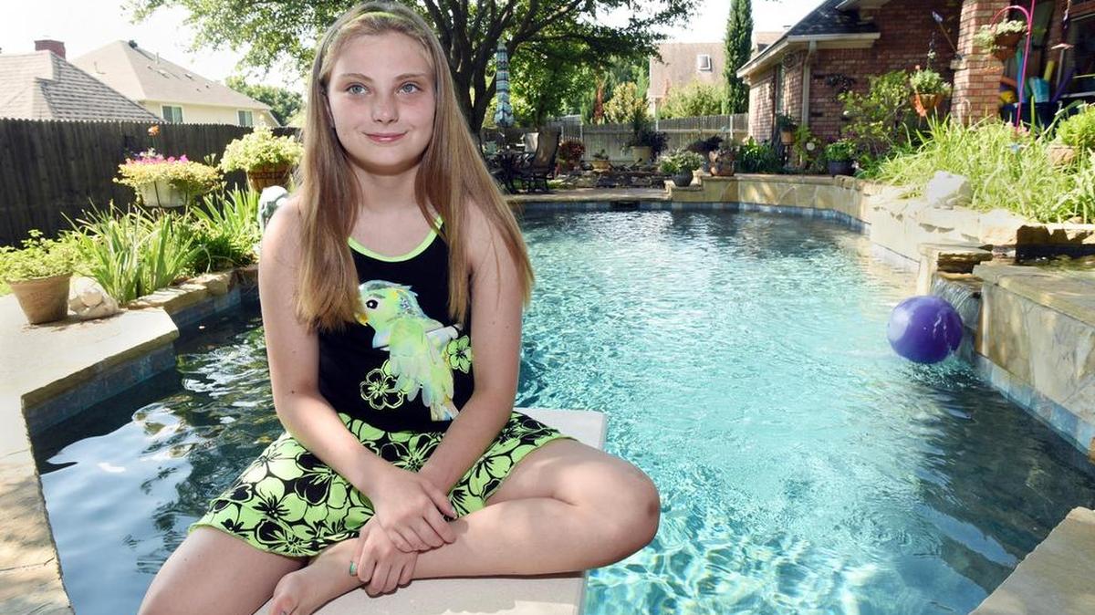 Justice Manning, 11, of Saginaw sits on the diving board of her grandparents’ pool in Keller Thursday. Manning is having a birthday party at the pool on Saturday but instead of asking for presents she would like for her friends to bring desserts or money donations for lunch for the Keller and Grapevine Police Departments. Manning's father is an officer with Grapevine police.