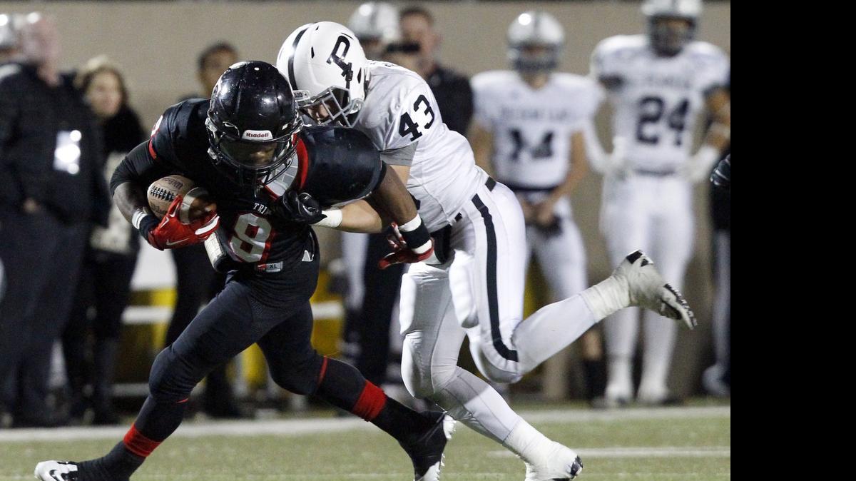 
Trinity’s De'Jaun Garrett, left, tangles with an Odessa Permian defender last season.
