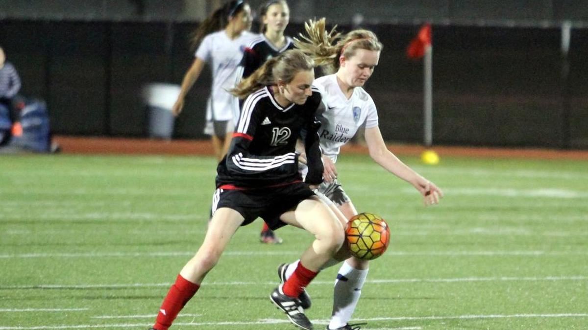 Alana Mangan, left, duels a Bell opponent for the ball last Friday. Mangan is one of seven freshmen on the team this season.