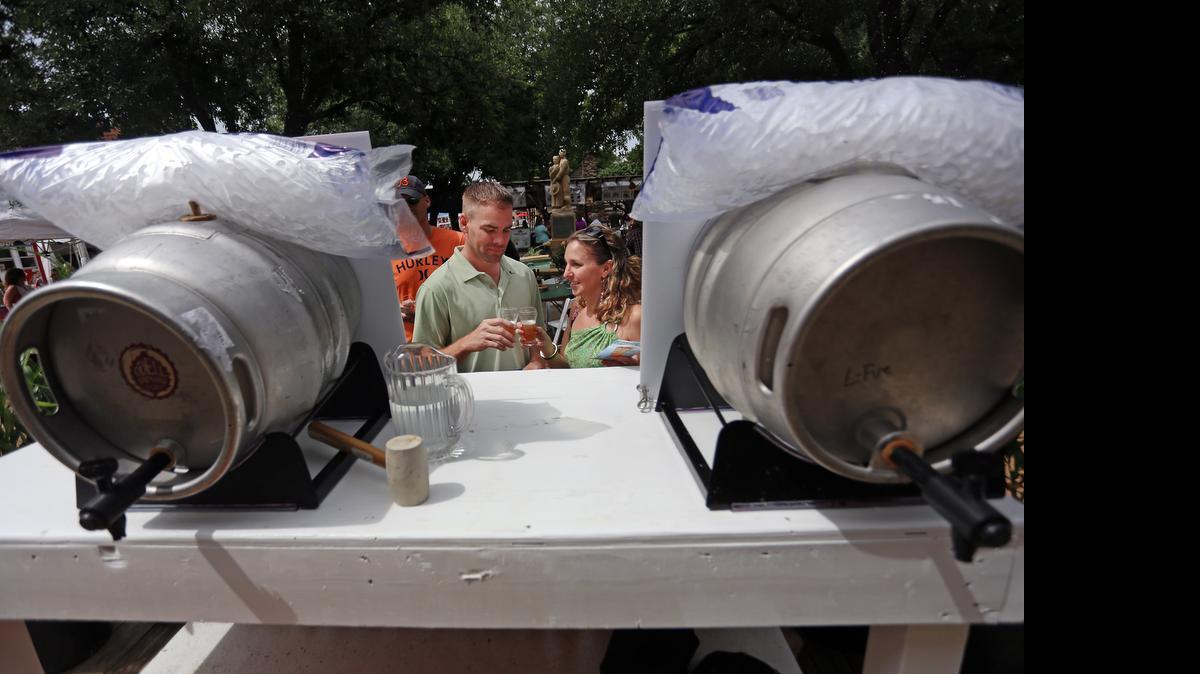 
Ben and Jaime Grider, of Highland Village, toast their samples of beer at the Craft Brew Experience. 
