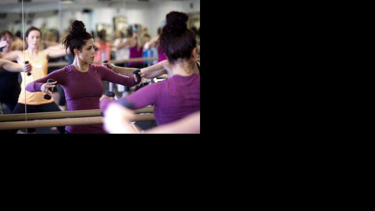 
Ashton Little works on her form during an exercise class at Cardio Barre in Southlake.
