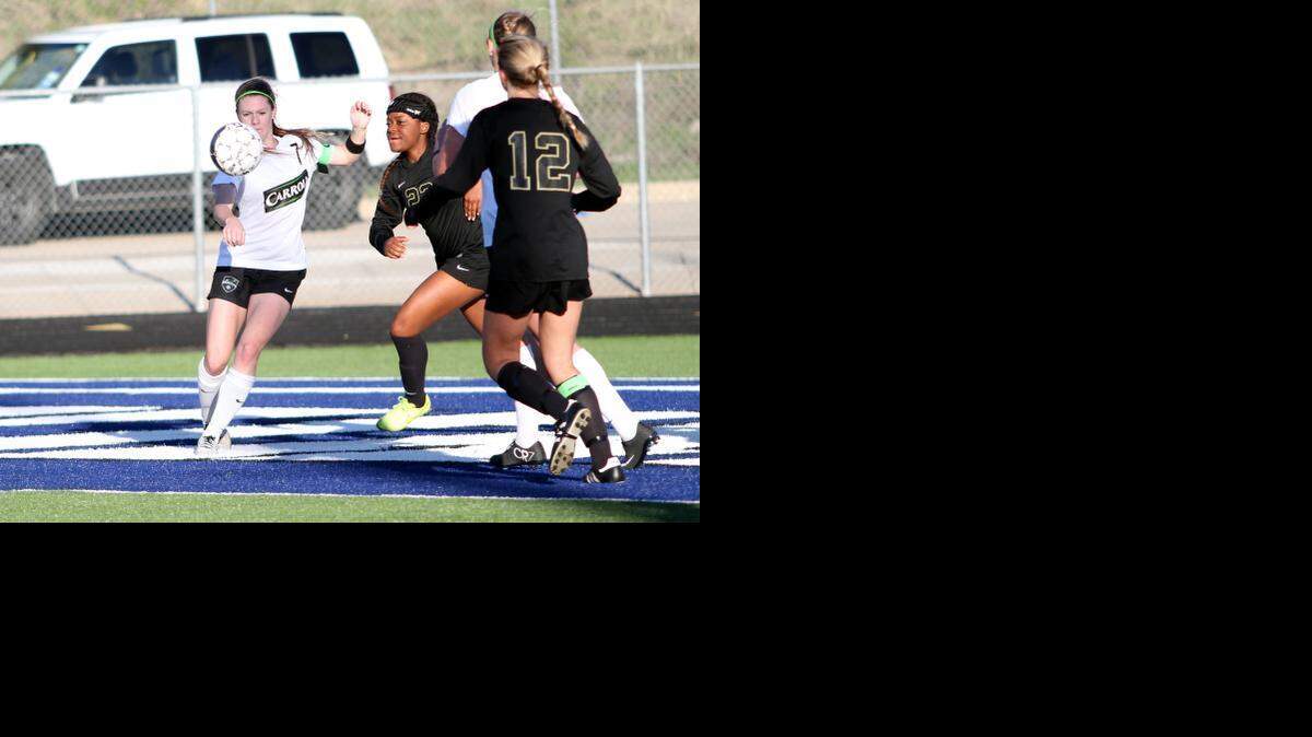 
Carroll’s Mary Meehan, left, tries to control the ball near the Mansfield goal last Thursday. Meehan scored all three Carroll goals in the 3-1 victory.
