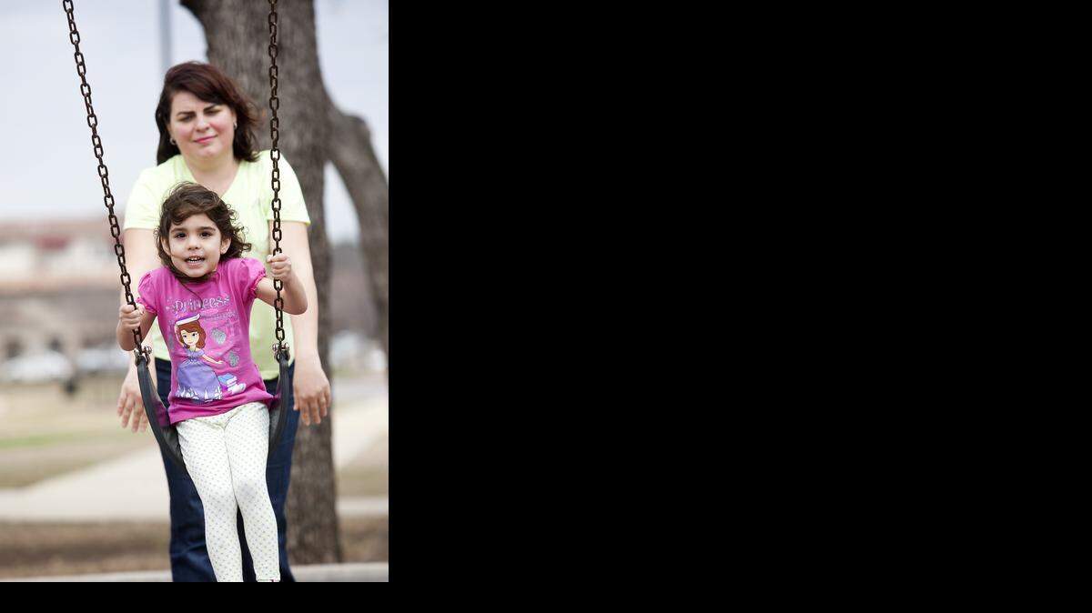 
Carmen Serban gives her daughter, Maya, a push at Colleyville City Park.

