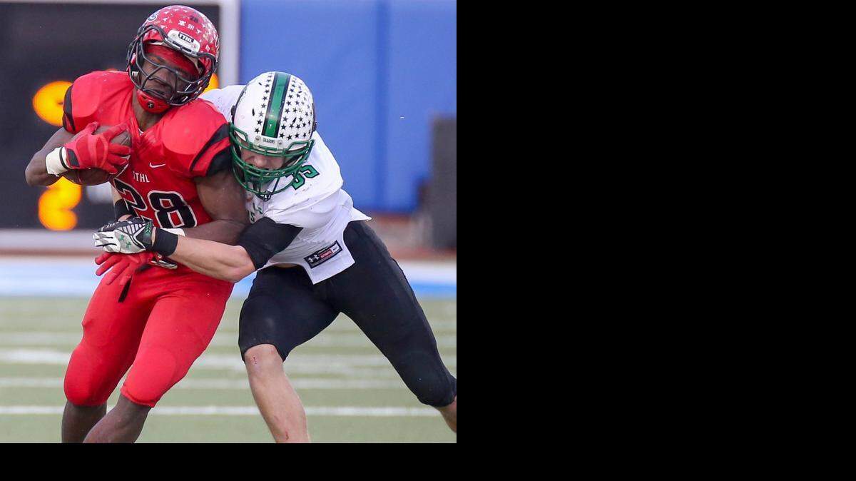 
Cedar Hill running back Aca'cedric Ware (28) is stopped by Carroll defender Coltin Nied (35) last Saturday. 
