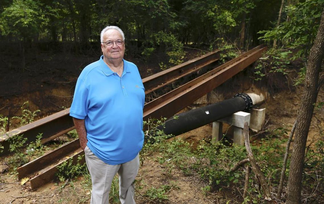 Trophy Club resident Danny Mayer stands next to a wastewater pipe spanning a drainage creek in Trophy Club. In 2016, a tree limb fell on the pipe causing it to spill 7,200 gallons of raw sewage into the creek, which feeds into Lake Grapevine.