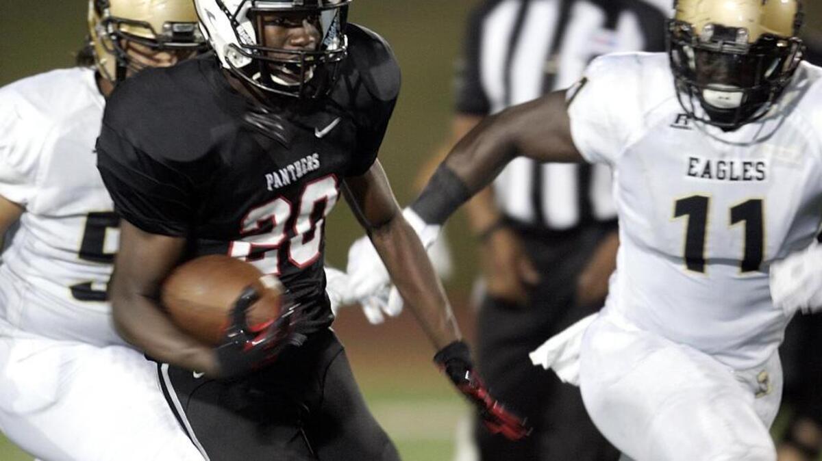 
Colleyville Heritage wide receiver Ke'Von Ahmad (20) runs past Abilene linebacker Ronnell Wilson (11) in Week 1.
