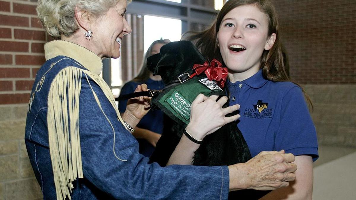 Peggy Nelson, Byron Nelson’s widow, presents Eva to her new raiser junior Corynne Turner at Byron Nelson High School Friday morning.