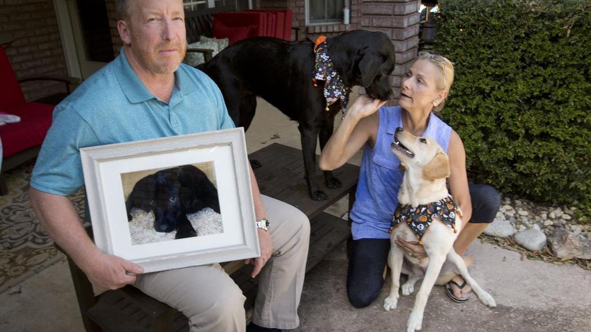 Haeger and Jennifer Long with their dogs Autumn and Annie Oakley at their Keller home. Haeger Long, holding a picture of their dog, Lola, says he being bullied by Keller police and the Tarrant County District Attorney’s office over a tragic accident.