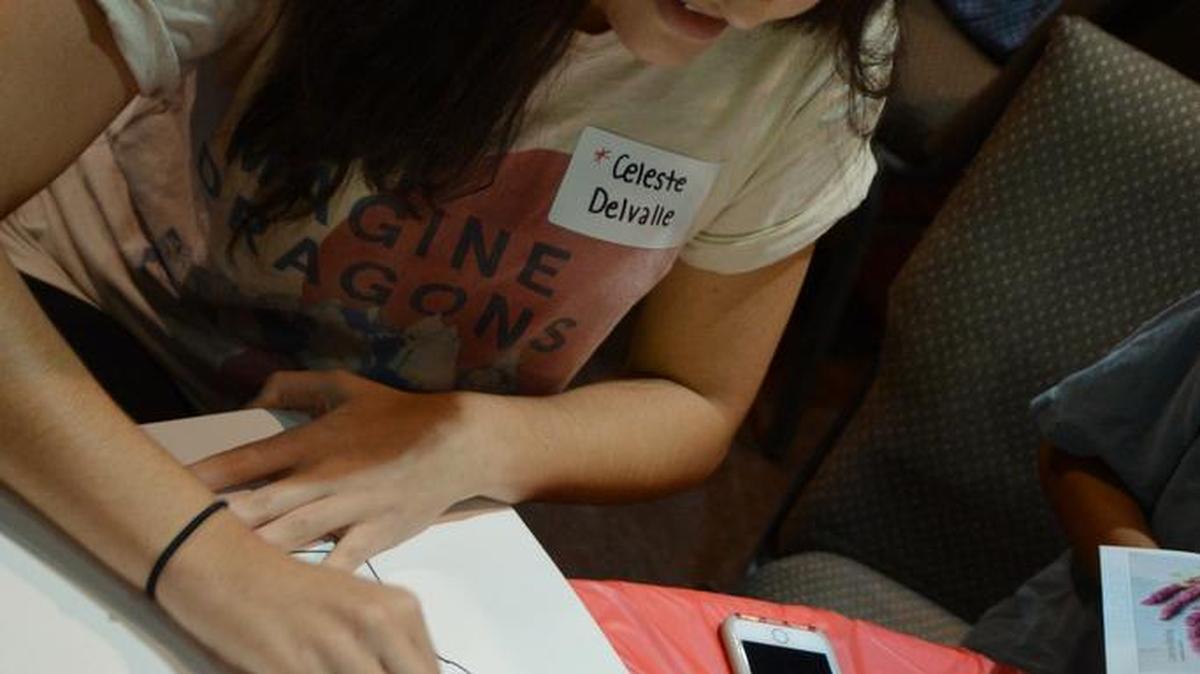 Celeste de Valle, 17, drew her symbols as crossed fingers as a sign of good luck durring the Art as Conversation event last week at Whites Chapel Church.