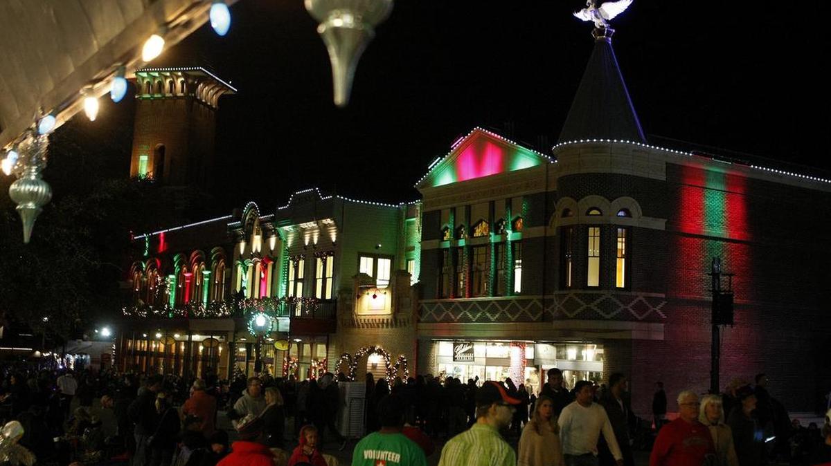 A crowd gathered before the Christmas parade in Grapevine on Thursday, Dec. 3, 2015, to watch the unveiling of a bronze winged unicorn sculpture atop the Grapevine Convention and Vistors Bureau headquarters.