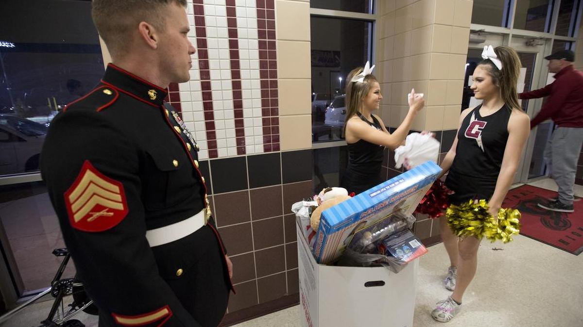 Central High School girls and boys basketball teams are collecting new toys for Toys for Tots. Marine Sgt. Kevin Shirley accepted toys from Central High cheerleaders Kyri Soto and Sydney Kimball on Dec. 5.