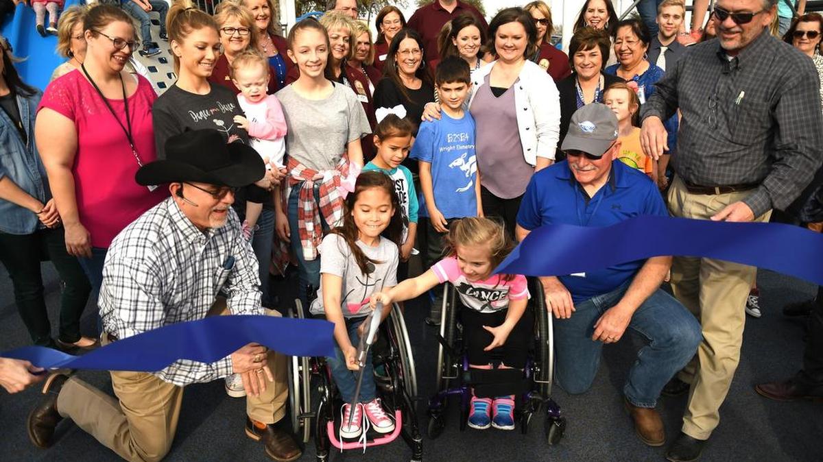 Mayli Gibson and Matti Bristow, both students a student at Curtis Elementary, cut the ribbon on the new all inclusive playground. Members of the Weatherford Chamber of Commerce were on hand to celebrate the occasion.