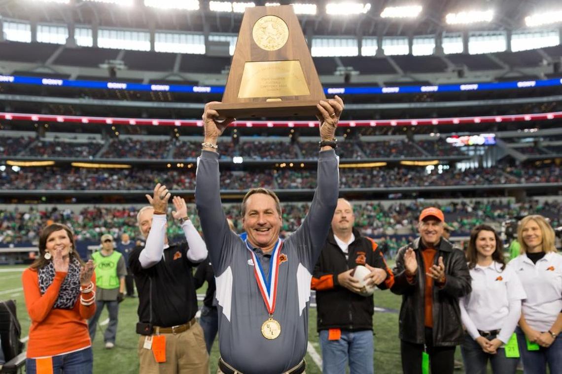 Tim Buchanan holds above his head one of the five state football championship trophies to which he coached the Aledo Bearcats. However, winning championships was only part of the legacy he leaves at Aledo as he announced his retirement, effective at the end of the school year.