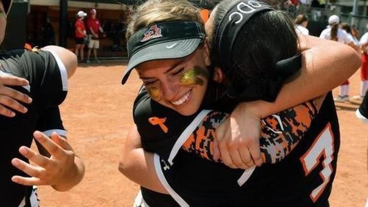 
Aledo senior third baseman Riley Sartain, center, gets a hug from teammate Olivia Dickey (7), while junior Kadyn Kirkpatrick, left, shares a hug with senior first baseman Chickie Cook (9) after the Ladycats’ 3-2 win over Cedar Park Vista Ridge. 
