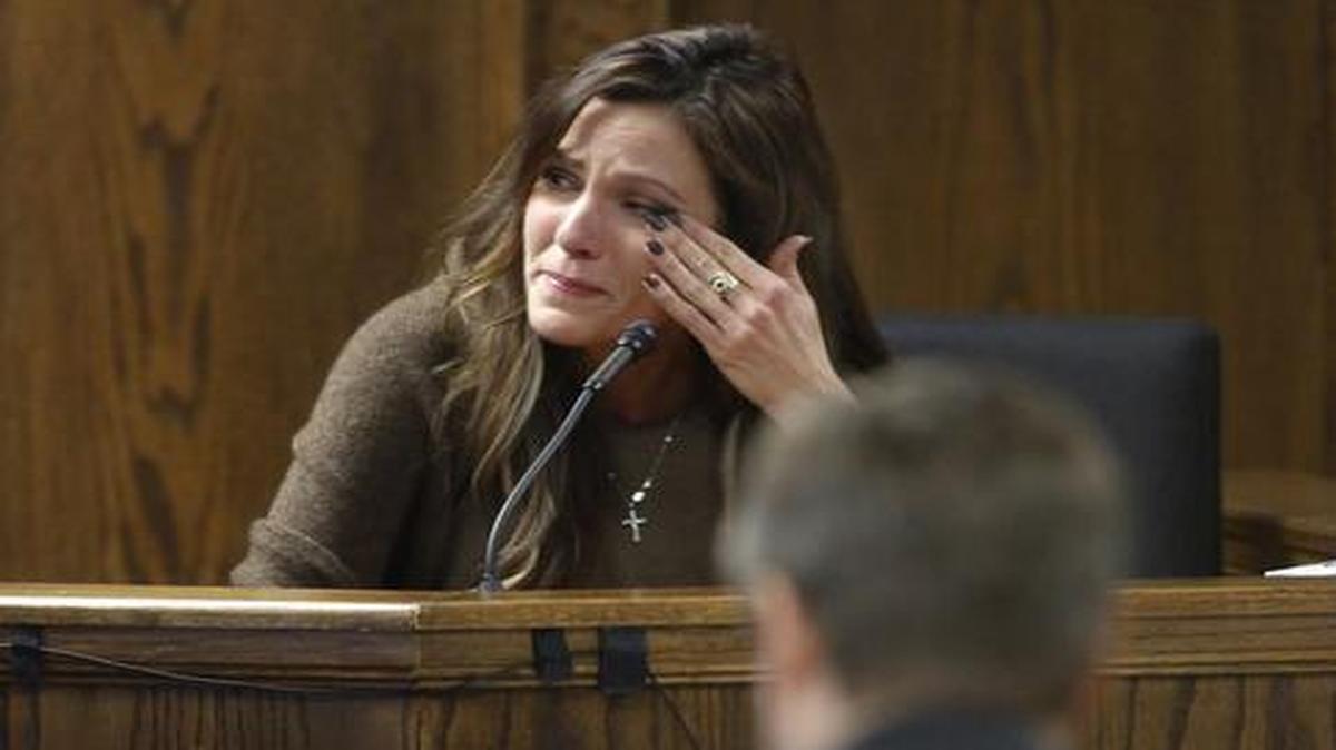 
Taya Kyle, wife of slain Navy SEAL Chris Kyle, wipes away tears when viewing images of her husband during her testimony Wednesday, Feb. 11, 2015. 
