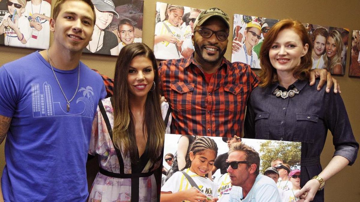 A 2014 file photo shows, fom left, co-hosts of the “Kidd Kraddick Morning Show” cast: Jose “J-Si” Chavez, Jenna Owens, Big Al Mack and Kellie Rasberry with a photo of Kidd Kraddick. The cast will be featured in “Kidd Nation TV,” a new syndicated series airing at 4:30 p.m. weekdays on KDFI/Channel 27.