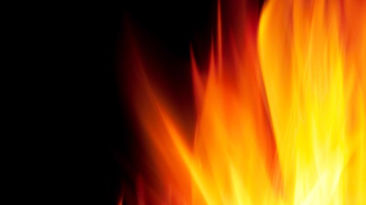 A man confessed to setting his vehicles on fire and spray-painting a racial slur on his garage door in Denton.