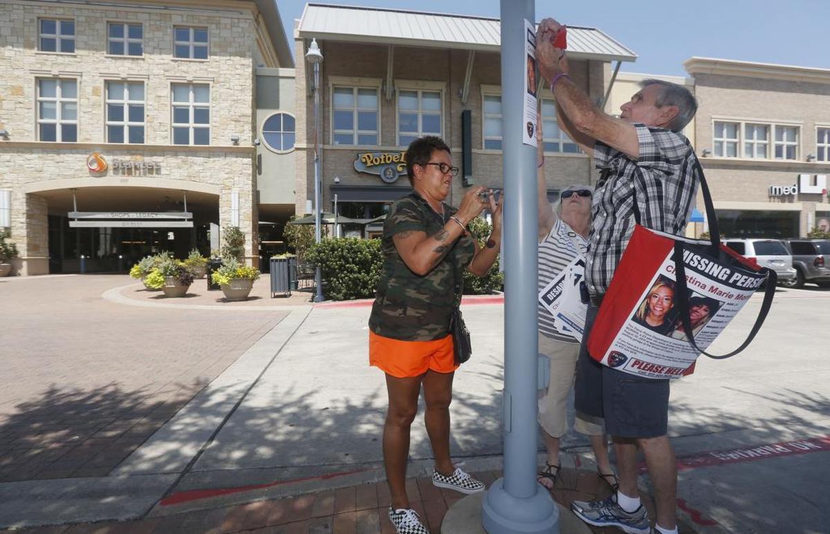 Mother Jonni McElroy, and grandparents Linda and David Morris put up "Missing" posters for Christina Morris outside The Parks at Legacy on Aug. 21, 2015.