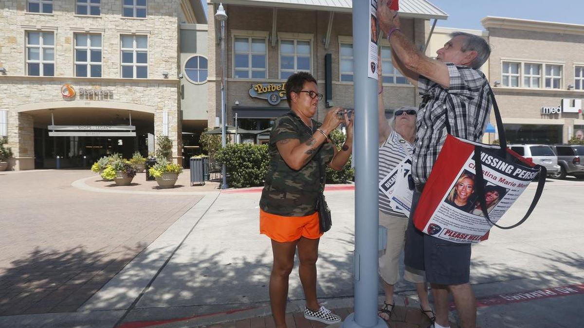 Mother Jonni McElroy, and grandparents Linda and David Morris put up "Missing" posters for Christina Morris outside The Parks at Legacy on Aug. 21, 2015.