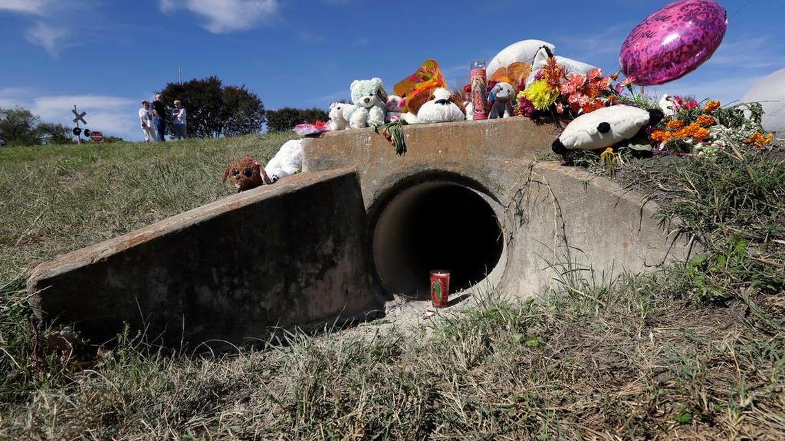 A makeshift memorial sits by a ditch drain Monday in Richardson. Police on Sunday found a body in the drain that is believed to be that of a 3-year-old girl who disappeared from her suburban Dallas home earlier this month.